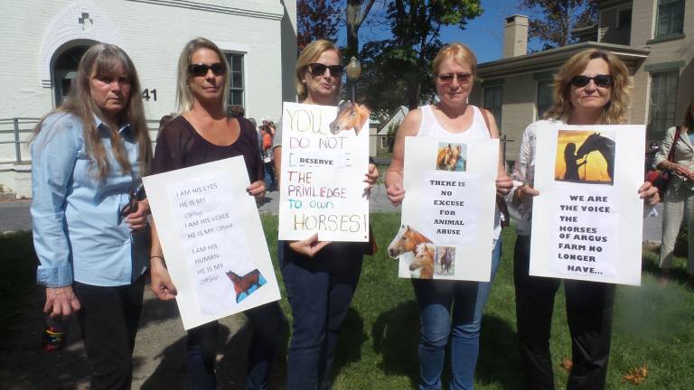 Farm owner accused in horses' deaths case may face felony charge Carol Maloney, Deb Lindeman, Maryanne Zambrzycki, Erica Karl, and Fran Pere carried homemade signs in a protest outside town court before Wednesday's hearing (Photo by Frances Ruth Harris)