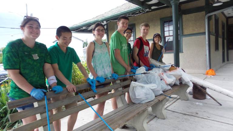 Brenna Lawson, Xuan Chen, Laura Edwards, Jacob Mott, Ekhine Avalos, Caleb Garver, and Sofia Balich with some of the bags of trash they picked up in the vicinity of the Erie Depot.