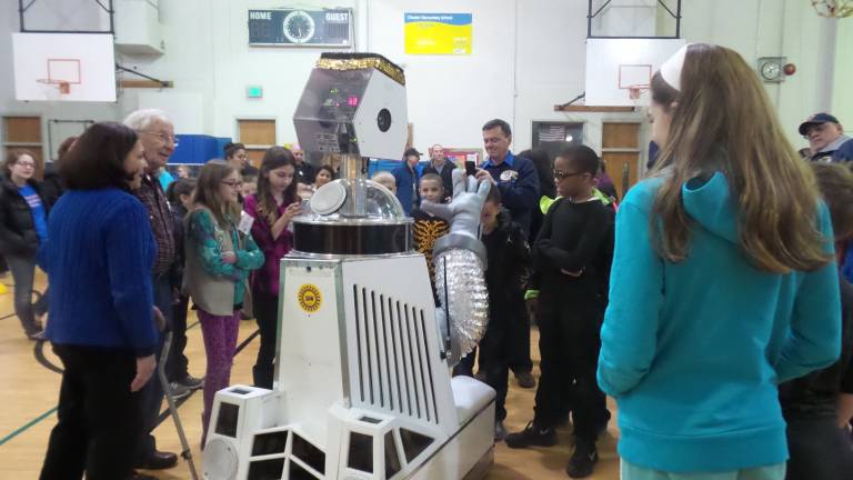 A fun night for science and math Parents and students converse with the robot.