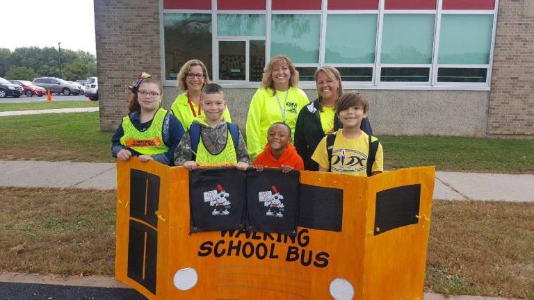 Anna S. Kuhl Elementary School school nurses Lori Sexton and Linda List, and physical education teacher Nicole Beam, coordinator of the Walking School Bus event with students. (Photo provided)