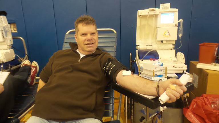 Hundreds give at Goshen blood drive School board member Tom Mullane donates (Photo by Frances Ruth Harris)