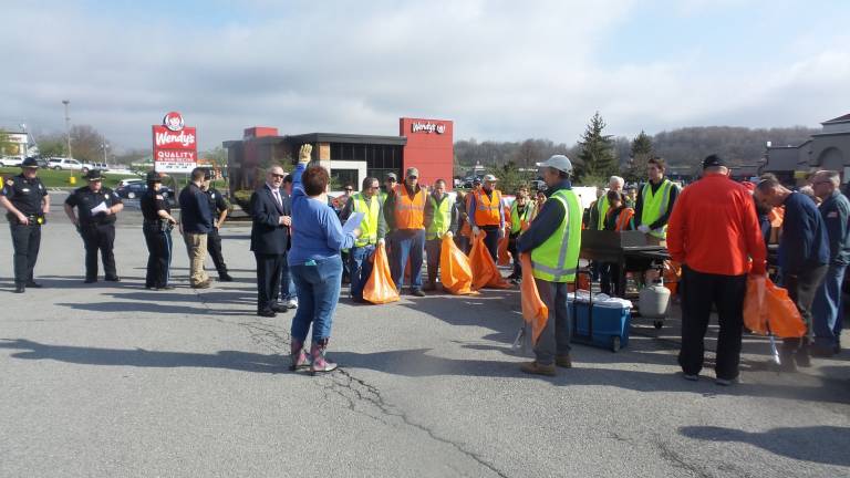 Many hands made light(hearted) work Sue Bahren gives instructions to volunteers (Photo by Frances Ruth Harris)