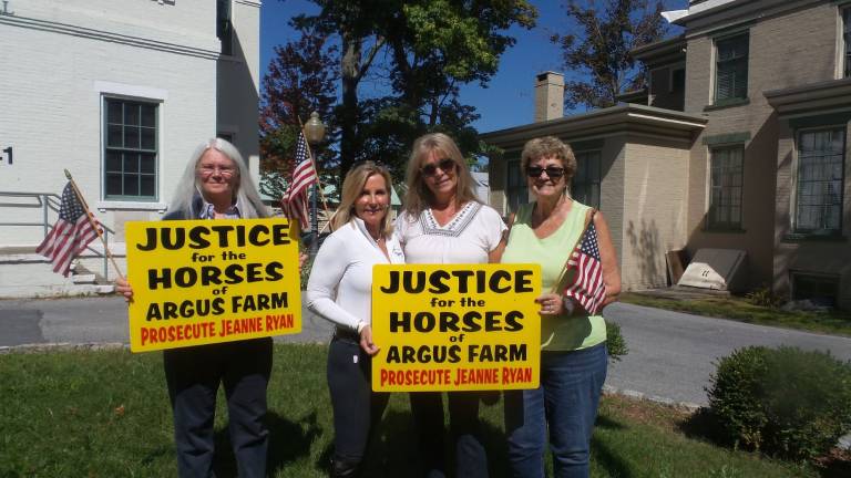 Farm owner accused in horses' deaths case may face felony charge Cheryl James, BJ Ehrhardt, Janet Hunt and Barbara Arent carried signs before Wednesday's hearing (Photo by Frances Ruth Harris)