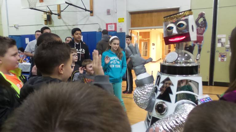 A fun night for science and math Kids give “high 5” to robot’s “high 4”