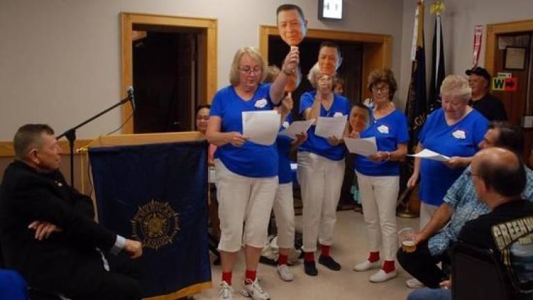 Ruthy Burgess, former organist for Holy Rosary created a song for the Mrs. Sweeney's performance. The Mrs. Sweeney's are the drivers who have driven for Father Bob over the years, and they all wore red socks like Father Bob frequently does. They each held up a paddle, which had a photo of Father Bob, and they raised it at different times to go with the music. Father Bob was asked to sit in a chair out front where they could sing to him.