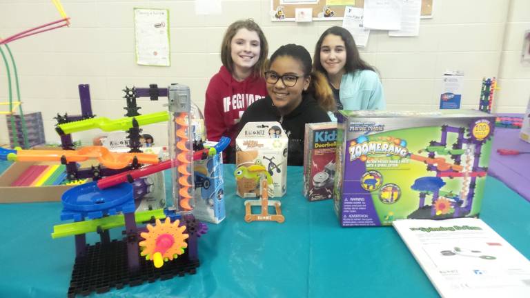 A fun night for science and math Camryn Vento, Ava Perez, Front, Amber Jimenez selling Fat Brain Toys