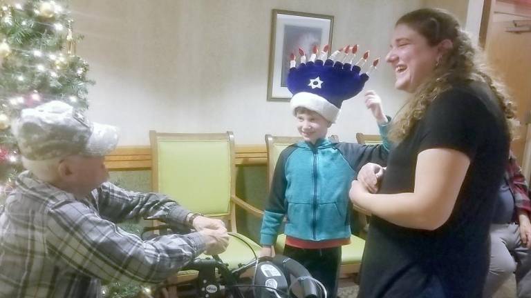 Becky Benezra and her son Cory of Monroe cheer senior citizens at W Senior Living in Goshen.