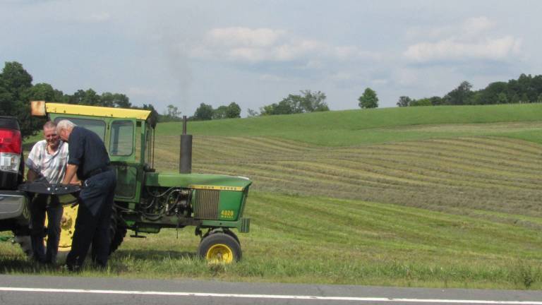 Bountiful fields help Irene-devastated farms recover Ted Talmadge (left) of Brookside Farm in Chester chats with a vendor while taking a break from baling his second cutting. His rolling hillsides are favored by local artists. (Photo by Edie Johnson)