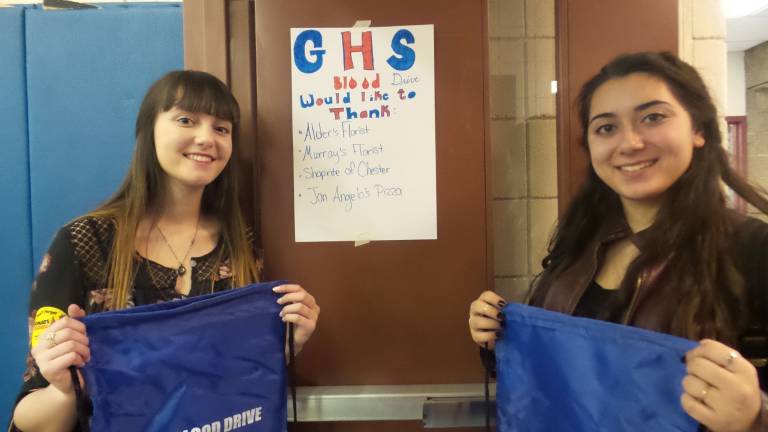 Hundreds give at Goshen blood drive Ally Bassani and Cara Petrizzo with thank you sign (Photo by Frances Ruth Harris)