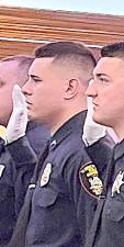 Ptl. Michael J. Glick, center, takes the oath upon graduation