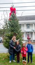 Sugar Loaf residents Colleen Mercedes with Aaron, Maryella, and Naomi stop for a picture in front of the Sugar Loaf Christmas Tree. Photos by Sammie Finch.