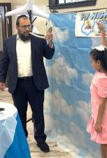 Rabbi Meir Borenstein showing the Shofar to a Chabad Sunday School student.