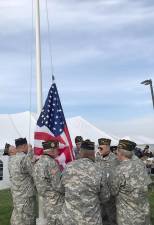 A new American flag is raised at Suresky's Auto by the Goshen colorguard, led by VFW Post 1708 Commander Ray Quattrini