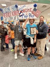 Students greeted veterans at the airport upon their return from Washington, D.C.