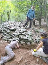Researchers with the University of Washington take sediment samples around a confirmed ceremonial stone landscape on Overlook Mountain, NY.