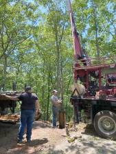 Well driller John Turnbull, Sr., and his son, John, Jr., rehabilitating well at Walton Lakes Estate. Photo courtesy of Tom Becker.