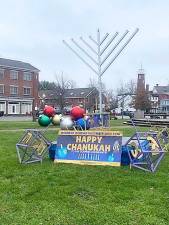 Goshen menorah lighting with music, chocolate money and giant dredel