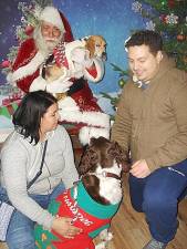 For a family photo, “Posey Bee,” a rescue beagle from Goshen, in Santa’s arms, and “Holly,” a springer spaniel, dressed up for the holiday. They posed with Mom and Dad, Joanna and Sal Pitonzo from Goshen. Both pets are 2 1/2 years old.
