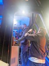 At 4:30 a.m. last Wednesday morning, Jan. 6, Assemblyman Colin J. Schmitt climbed the steps of one of two buses in Monroe Park-and-Ride to say a few words to the people on board who were getting ready for the five-hour ride to Washington, D.C., where people from across the country were gathering to protest the Congressional certification of Joseph R. Biden as the next president of the United States of America. Photo provided by the Orange County Democratic Committee.