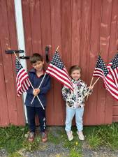 Leo (left) and Noelle DiMontova proudly hold their flags.