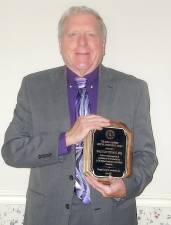 Attorney Malcolm Stewart holding his Lifetime Achievement Award given him by the Orange County Bar Association “In Honor and Recognition of Excellence In The Practice of Law at The Highest Professional And Ethical Standards.” He received the award on Wednesday, June 23. Photo by Geri Corey.