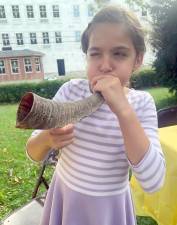 Maddy from Goshen blows on her shofar at a shofar factory Chabad of Orange County in Goshen held in honor of High Holiday season. Photos provided by Rabbi Meir and Rivkie Borenstein.