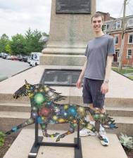Mitchell Saler stands with his Painted Trotter at the Orange Blossom Memorial in the Village of Goshen.