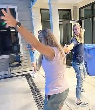 Michelle Muller, Assistant Director of Goshen Public Library, dances with Junior Friends member Ana Loter.