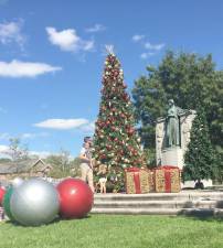 On the set of Hallmark’s latest Christmas movie, “One December Night,” being filmed in the Village of Goshen, the questions become: How does a dad explain to his daughter about Christmas in late September, what with the tree, presents and ornaments at the Soldiers and Sailors of Orange County Monument at the corner of Main and South Church streets in the middle of Goshen and with the temperatures in 70 degrees Fahrenheit? And how do you answer so early in the season: “Where is Santa?” Photos by Bob Quinn.