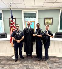 Photo Right to Left: Officer Natalie Welsh, Officer Nigel Balgobin, Justice Seamus Weir, Officer Antonio Esposito.