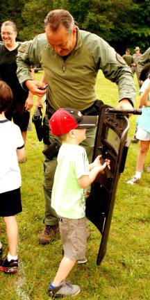 Aiden Delo, 5, checks out a ballistic shield. (Photo by Ed Bailey)
