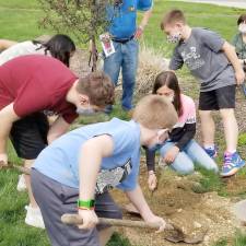 All of the students got to participate in filling the hole and making sure the ground was properly watered and mulched.