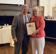 Goshen Lions Club President Ken Tschan presents Lion Cecile Ayres with the Melvin Jones Fellowship Award. Melvin Jones was the Founder of the Lions in Chicago, 1915. The award is the highest honor that can be achieved throughout Lions Clubs International. Cecile has been a dedicated and active member for 30 years.