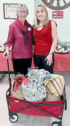 Kim Regensdorfer (right) accepted comfort bags made by guild members for foster children to use in times of transition. She is pictured with Anne Sigler, guild member and project coordinator.