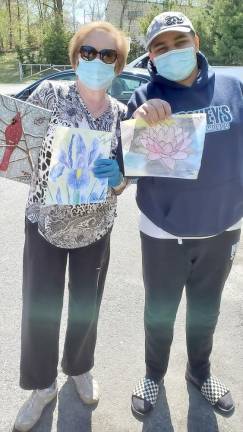 Aiden Axler, 14, of Highland Mills and his grandmother, Bonnie McCarthy, pose with art they created and donated to helps bring Simcha (joy) for Seniors at W Senior Living in Goshen at Chabad’s Honk for Heroes Car Parade.