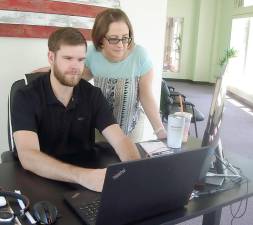 Agent Zach Schiller and Office Manager Kerri Losey at work in their Goosehead Insurance agency, located at 25 Main St., Goshen. Photo by Geri Corey.