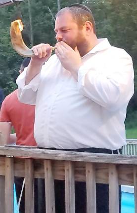 Rabbi Pesach Burston blows the Shofar, in preparation for the High Holidays, and to “start the Summer Social BBQ on a high note,” he joked.