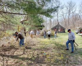Members of the Goshen Rotary spent a portion of last Saturday clearing an overgrown berm on the property of the Old Stone Schoolhouse on Route 17A in Goshen. Provided photos.