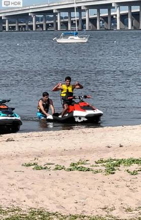 Anthony Mitchell and Rhyse Ruffy arrive on shore after helping a stranded boater.