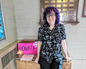 Goshen High School senior Rox Aclin with a donation box at Fellowship Hall at First Presbyterian Church.