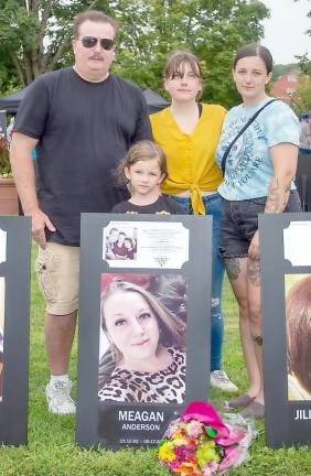 The family of Megan Anderson came to view the Black Poster Project and laid flowers beside her poster. The mom of two lost her battle with addition after the COVID-19 pandemic limited in-person therapy.