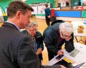 Clifton and Leslie Patrick talk to Brian ten Siethoff at the final Orange County 2045 Long Range Transportation Plan public workshop Nov. 6 at the South Orange Family YMCA.