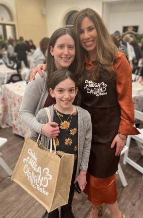 Mother and daughter Michelle and Heather Sentell of Monroe, together with Chana Burston, enjoy baking Challah together at the Chabad of Orange County’s Mega Challah Babka Bake.