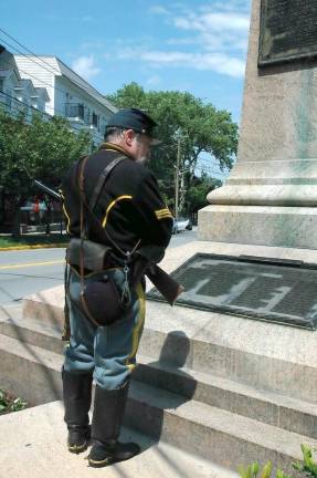 Patriotic Instructor Rick Frustraci reads the names of the fallen on the 124th New York Infantry Monument in Goshen.