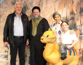 (L-R) Elias Muhlrad of Goshen, with Rabbi Pesach and Chana Burston, and Rivkah Burston get ready for Arabian Nights community Purim party at Chabad of Orange County.