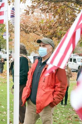 Village of Goshen Mayor Michael Nuzzolese listens as the names are read aloud.