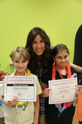 Phineas Landgraff of Tuxedo and Abby Ohren of Monroe, pictured with Chana Burston, display their certificates of accomplishments (Photo provided)