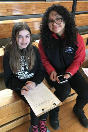 Jillian Pucci, left, is with Karia Paulino as the log results for team members doing trial runs. Pucci, a 6th grader still CJH Middle School is very new to Science Olympiad, but loves it because she was happy to find out about a club that lets her work on science subjects.