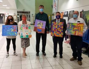 Chester Board of Education members were recently presented with artwork created by CES students. Pictured from left to right are: Dawn Guevara, Vice President Sandy Nagler, Keith Brideweser, President Frank Sambets and John Pasichnyk. Photos provided by the Chester School District.