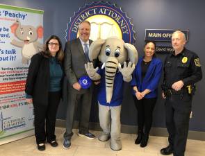 From left to right: Shannon Kelly, CEO of Catholic Charities of Orange, Sullivan &amp; Ulster; Orange County District Attorney David Hoovler; Francesca Bryson, Catholic Charities Coalition Coordinator for TEAM Newburgh; and Town of Goshen Chief of Police James Post pose with Peachy, the Prevention Elephant. Photo provided.